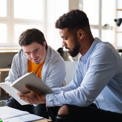 Direct Support Professional (DSP) reading a book