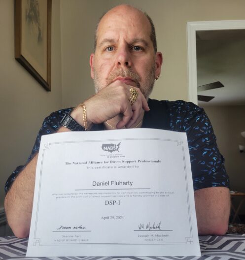 Daniel Fluharty holding his certificate for NADSP Level I
