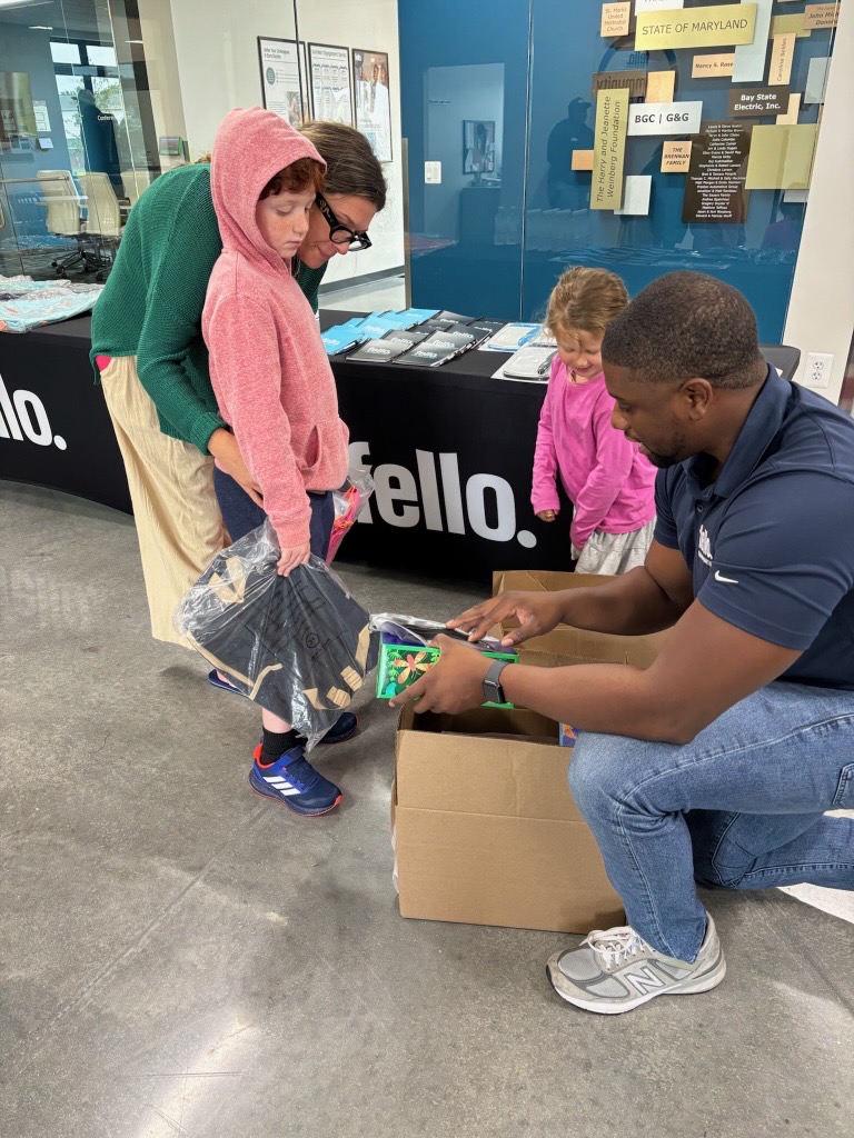 Keenan Troxler, Assistant Director of Property Operations handing out supplies to a family