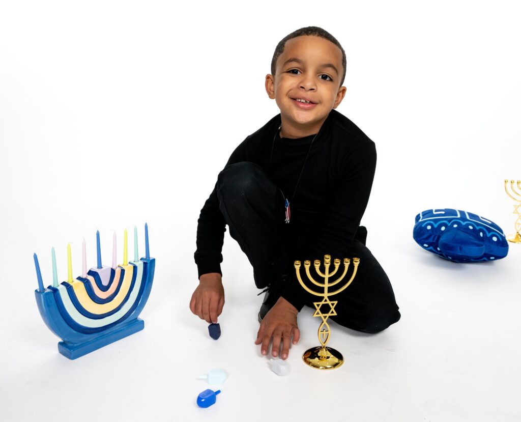 Young boy with a Hanukkah menorah