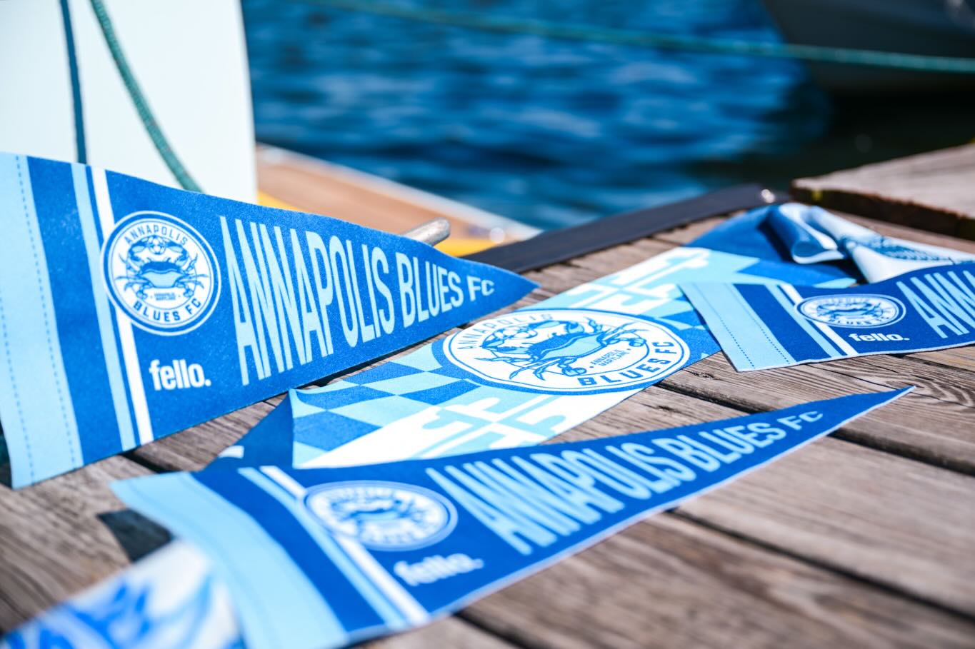 Blue pennant flags with Annapolis Blues FC and Fello logo
