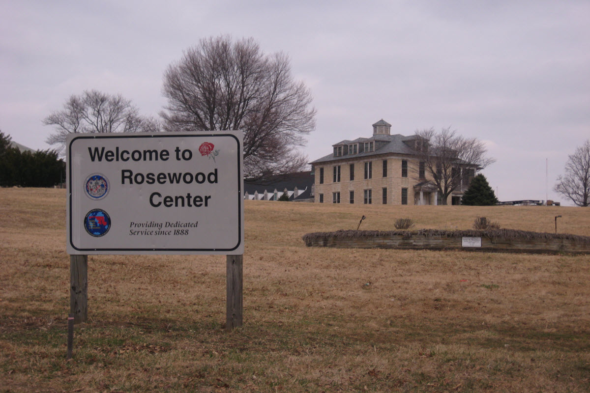 The Rosewood Center in is the background with a sign that says 'Welcome to the Rosewood Center" in the foreground.