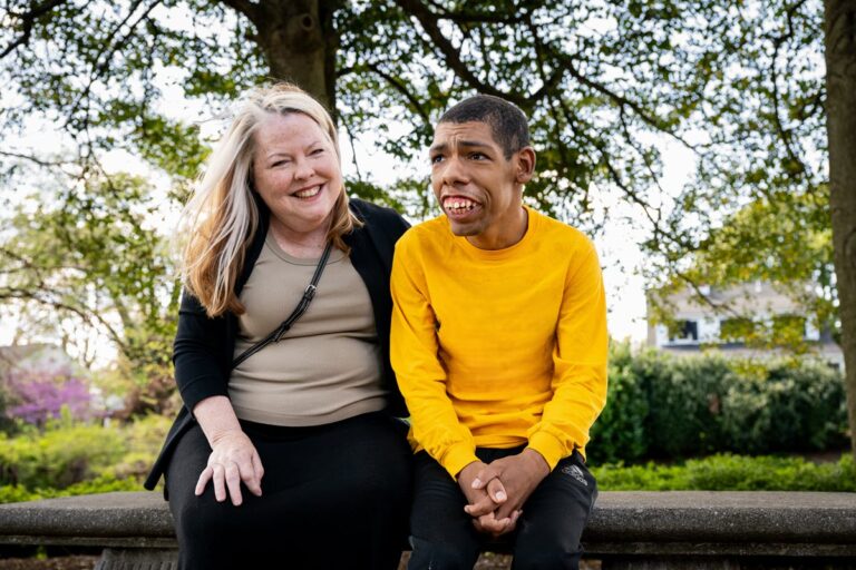 Tammy and Jack sitting on a bench in a park.